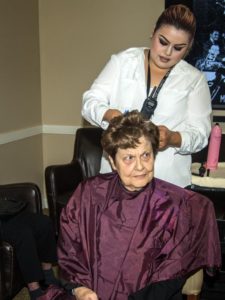 Cheryl McDaniel getting a haircut by Diana Ornelas.