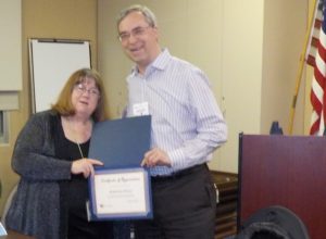 Katherine Raley, Health Insurance Counseling & Advocacy Program (HICAP) Program Manager, accepts an award from Phil Chandler, Mended Hearts Program chair, after a presentation on Medicare.