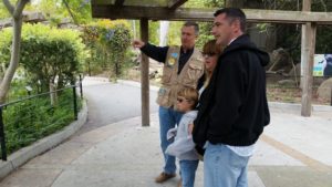 Volunteer Paul Kremser pointing out gibbon behavior to zoo visitors. 