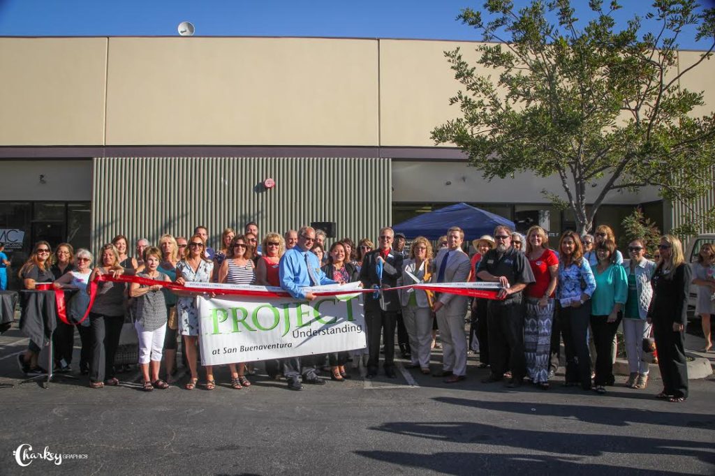 Project Understanding celebrates with ribbon cutting at their new location. Photo by Charleen Morla