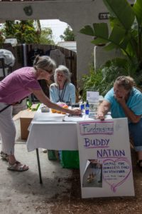 Helping raise funds at a garage sale for Buddy Nation are Rebecca Nelson , Cappi Patterson and Penny Balicai. Photo by Bernie Goldstein