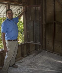 Ed Sanchez at a window restoration project being completed on Poli St.