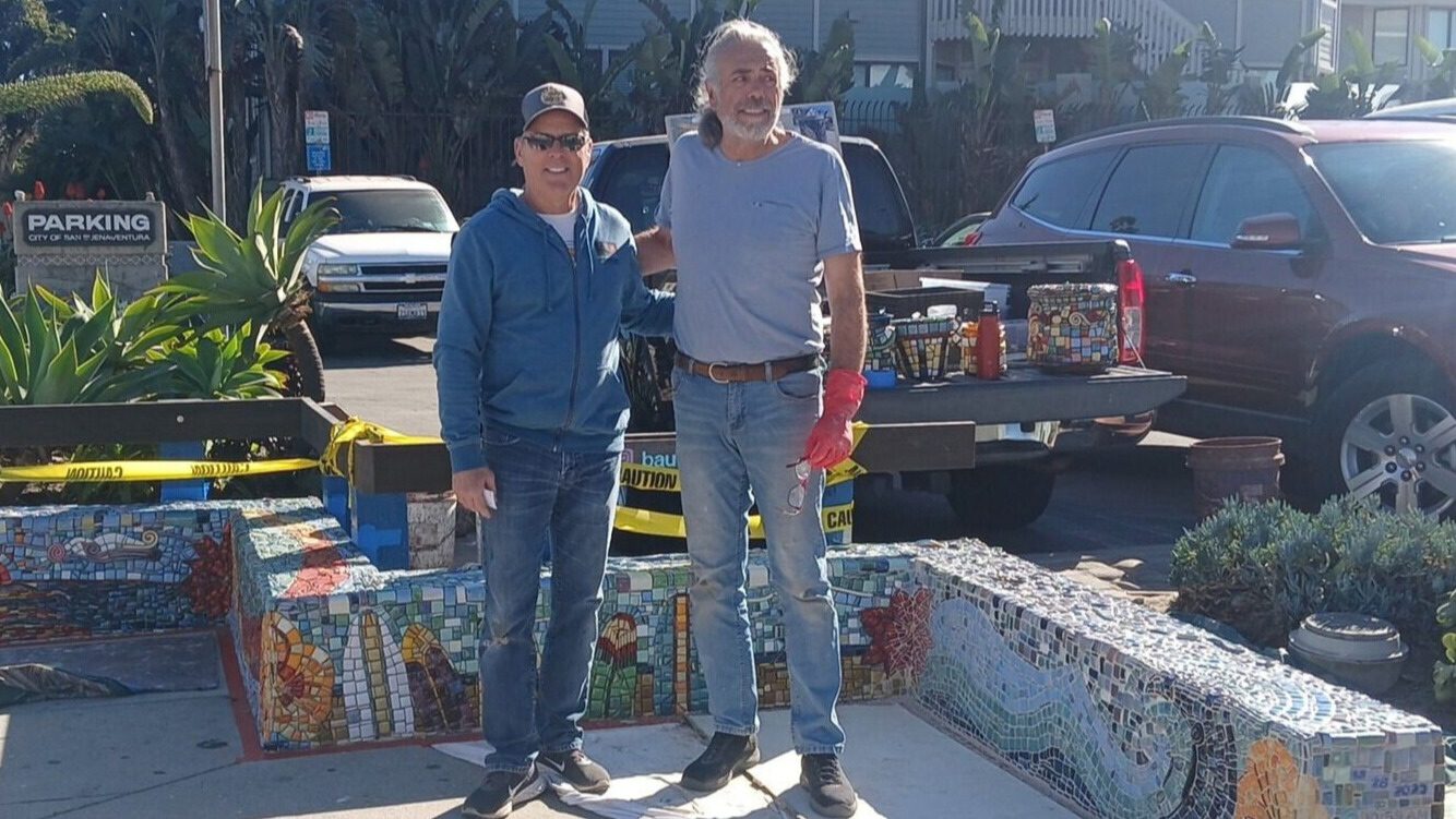 Artist Frank Bauer (right) and Dan Roundtree from the Pierpont Bay Council during work on the new mosaic benches.