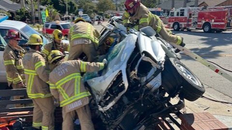 Firemen rescuing people in a car