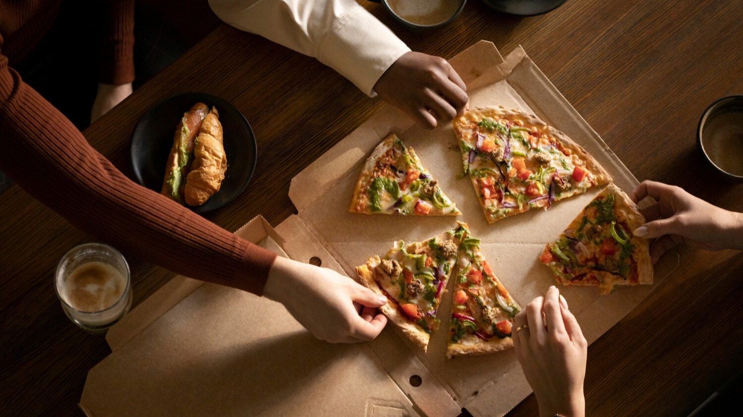 Slices of pizza served on a table in a restaurant.
