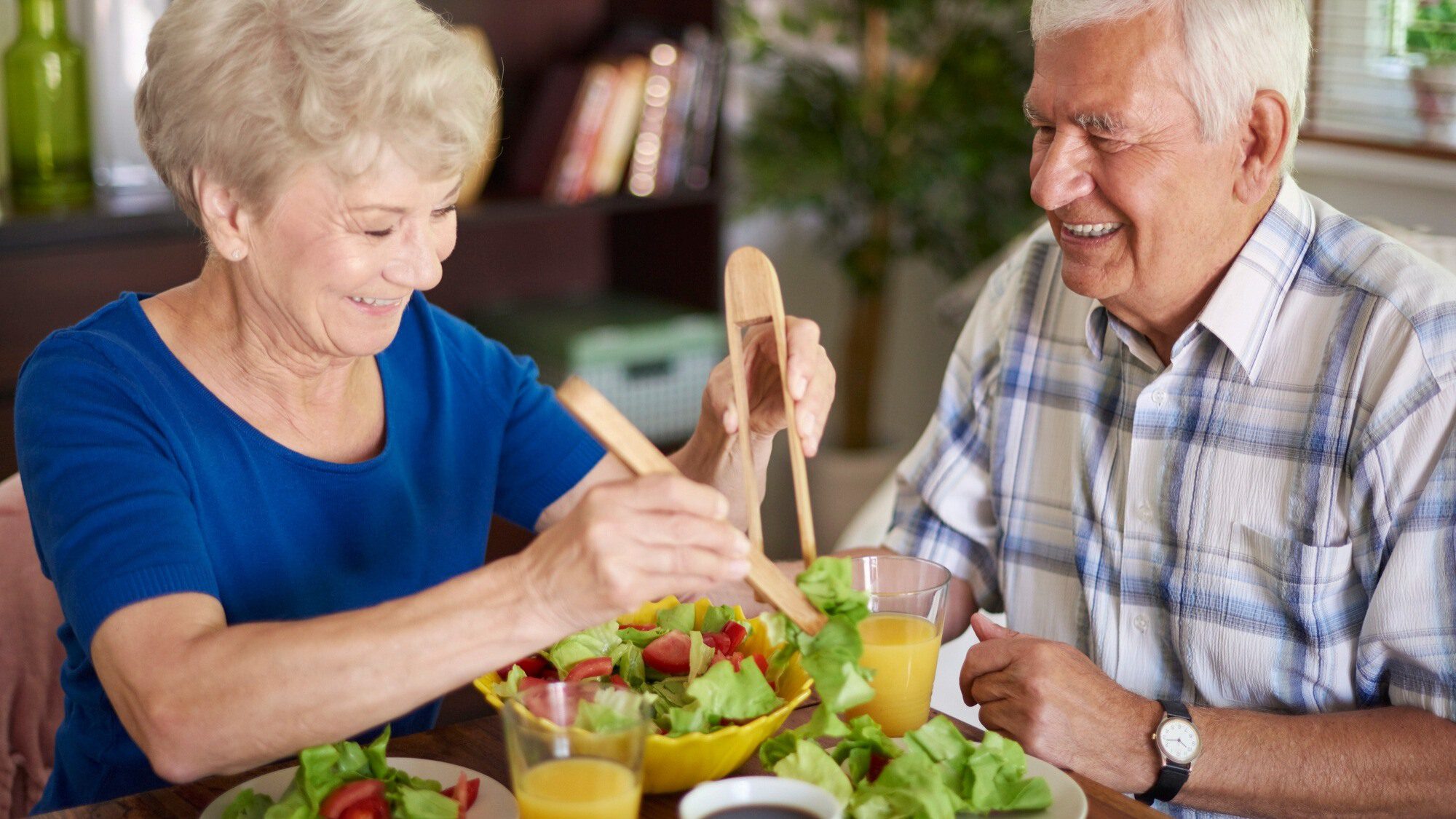 two seniors eating salad