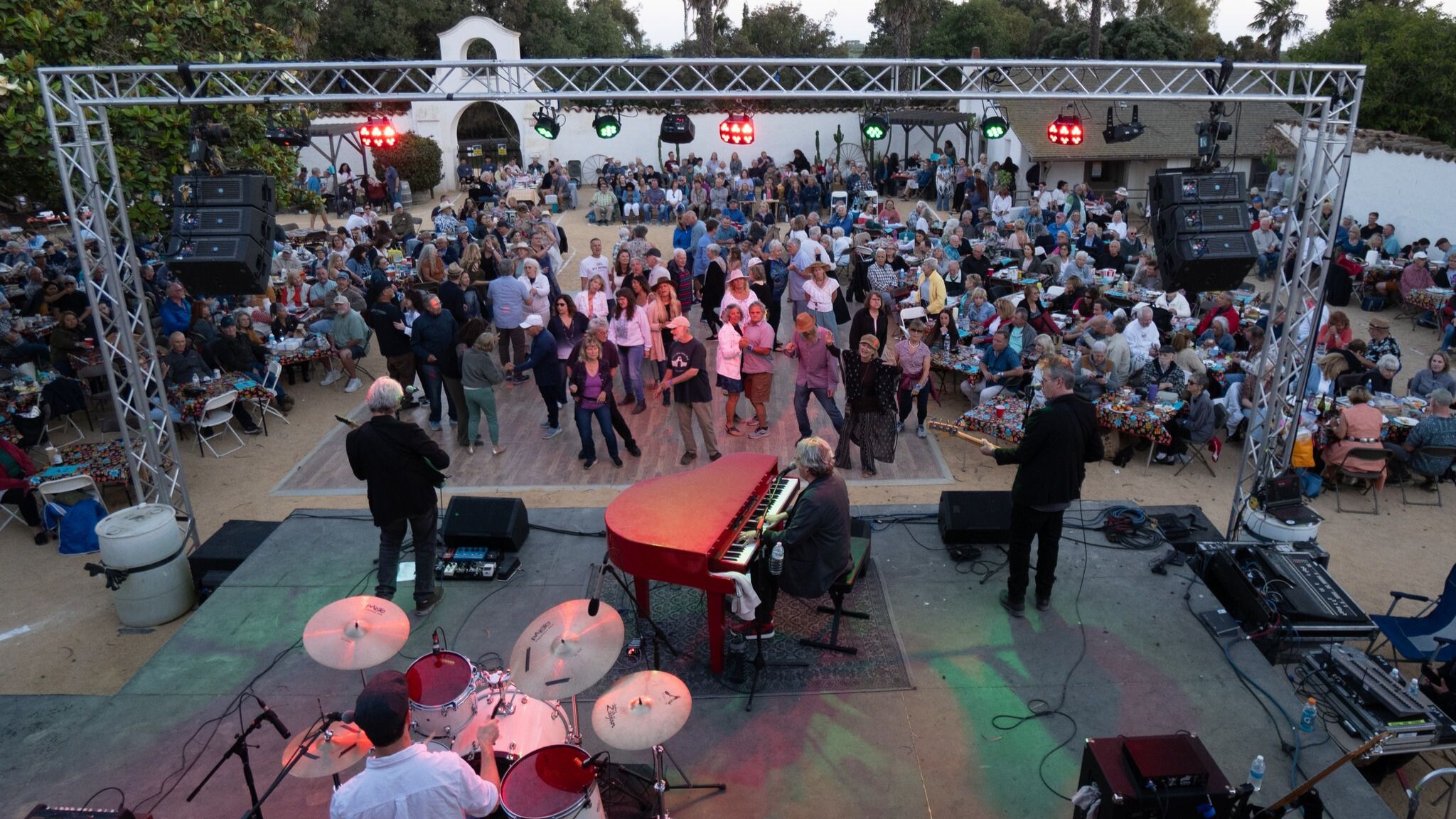 Olivas Adobe event featuring a band and dancing audience.