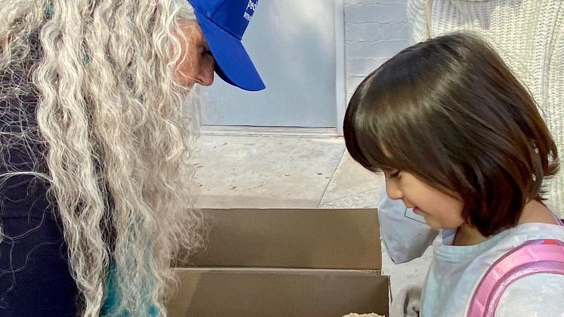 Christine Burke handing out food to children in Pasadena.