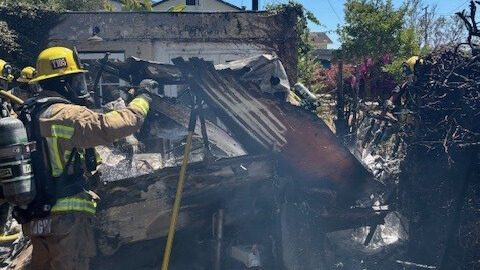Fireman standing near burned car