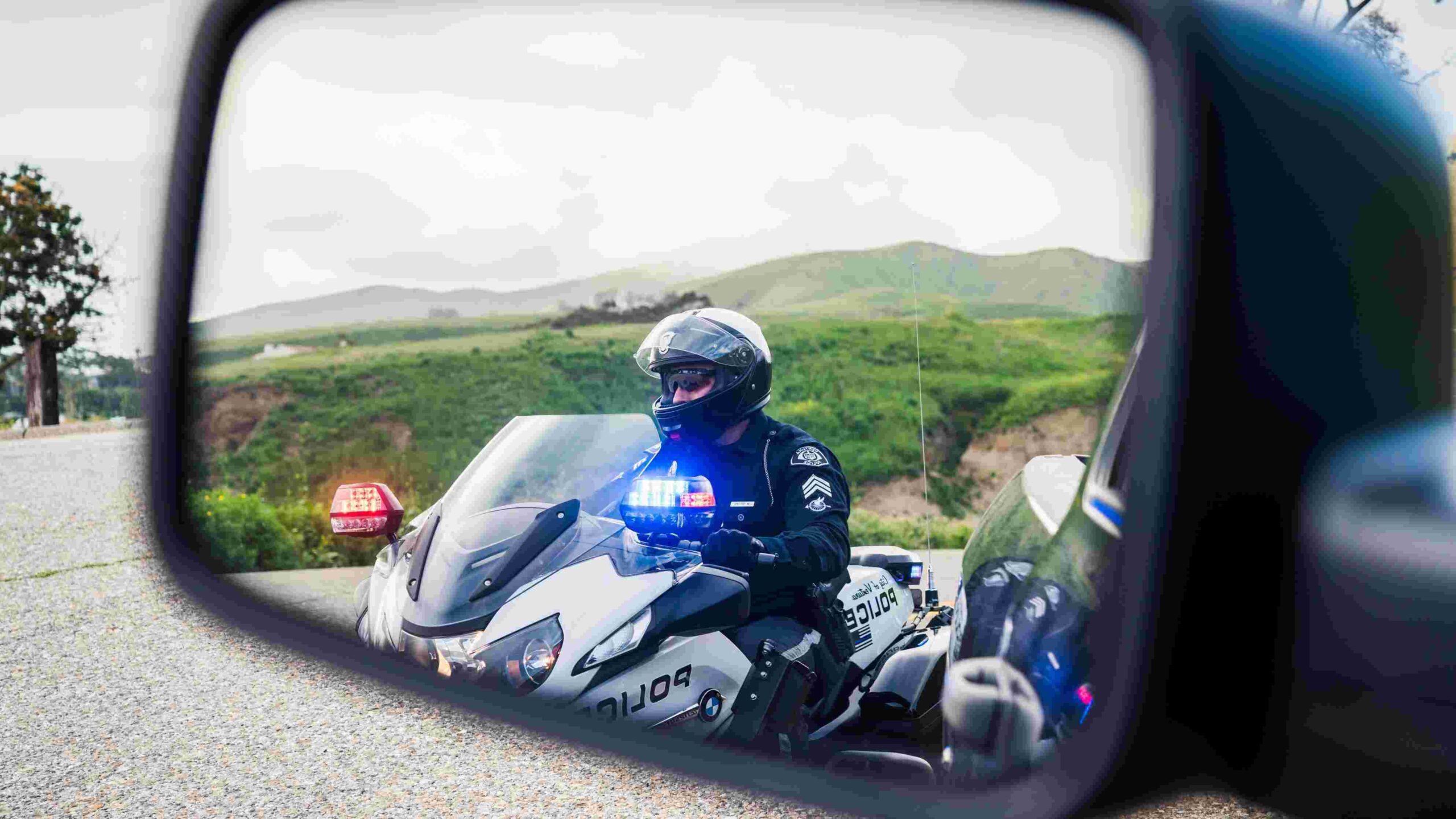 Police motorcycle in side view mirror
