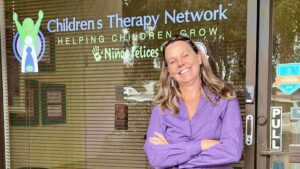 Dr. Cassandra Woods-Pierce standing in front of Children's Therapy Network