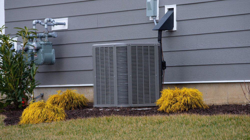 Photo of heat pump on side of house