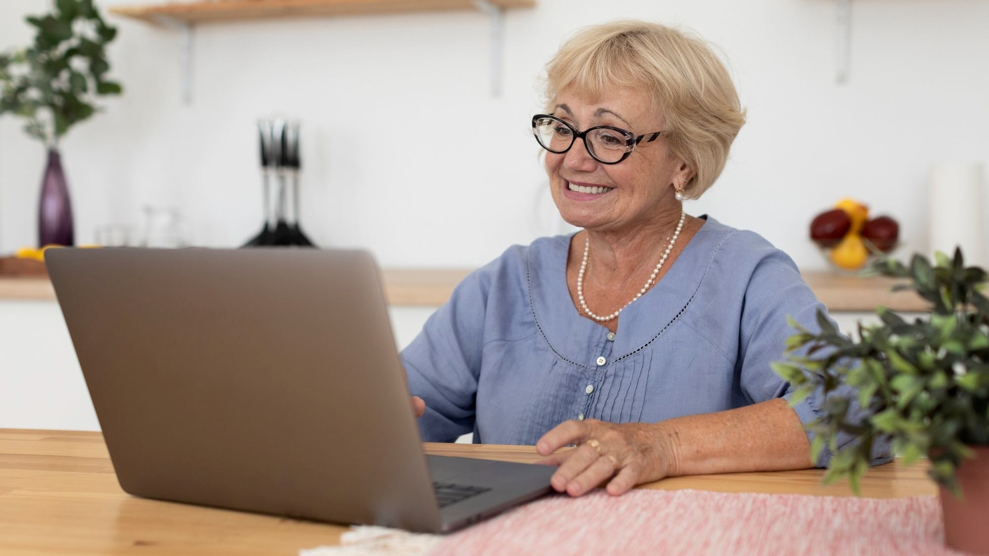Image of elderly woman looking at a computer