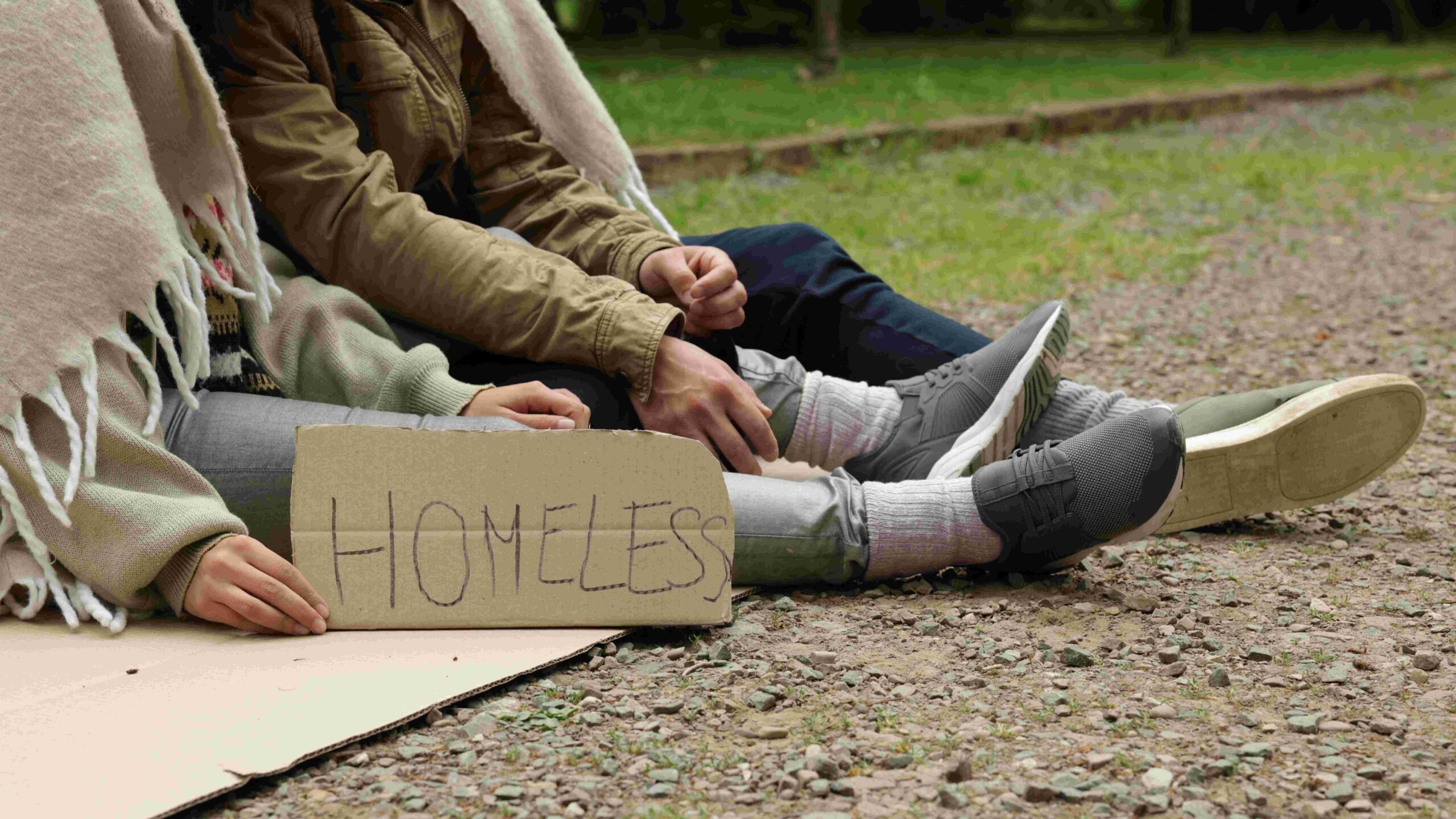 Image of homeless man with cardboard sign