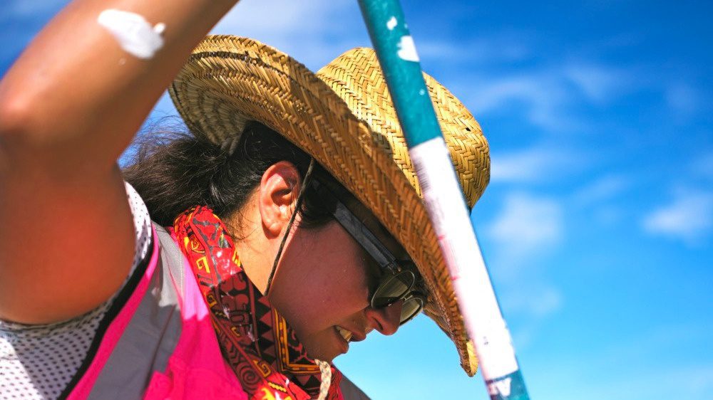 Image of woman in pink vest painting