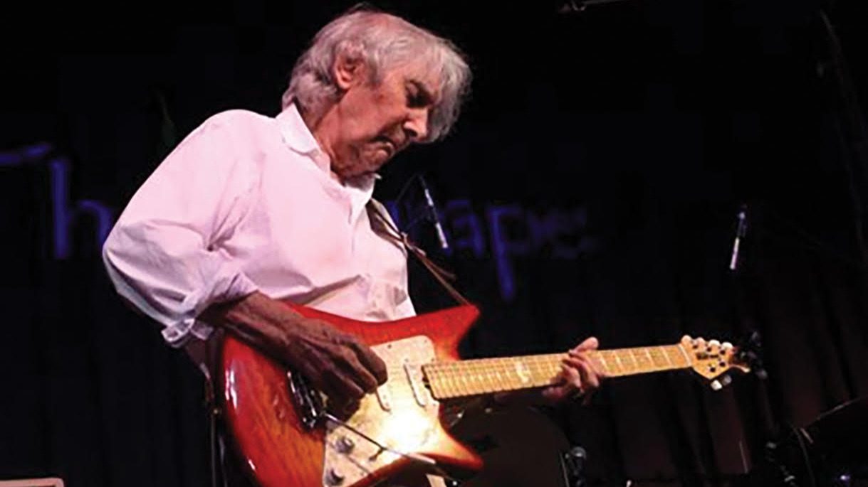 Photo of man playing electric guitar