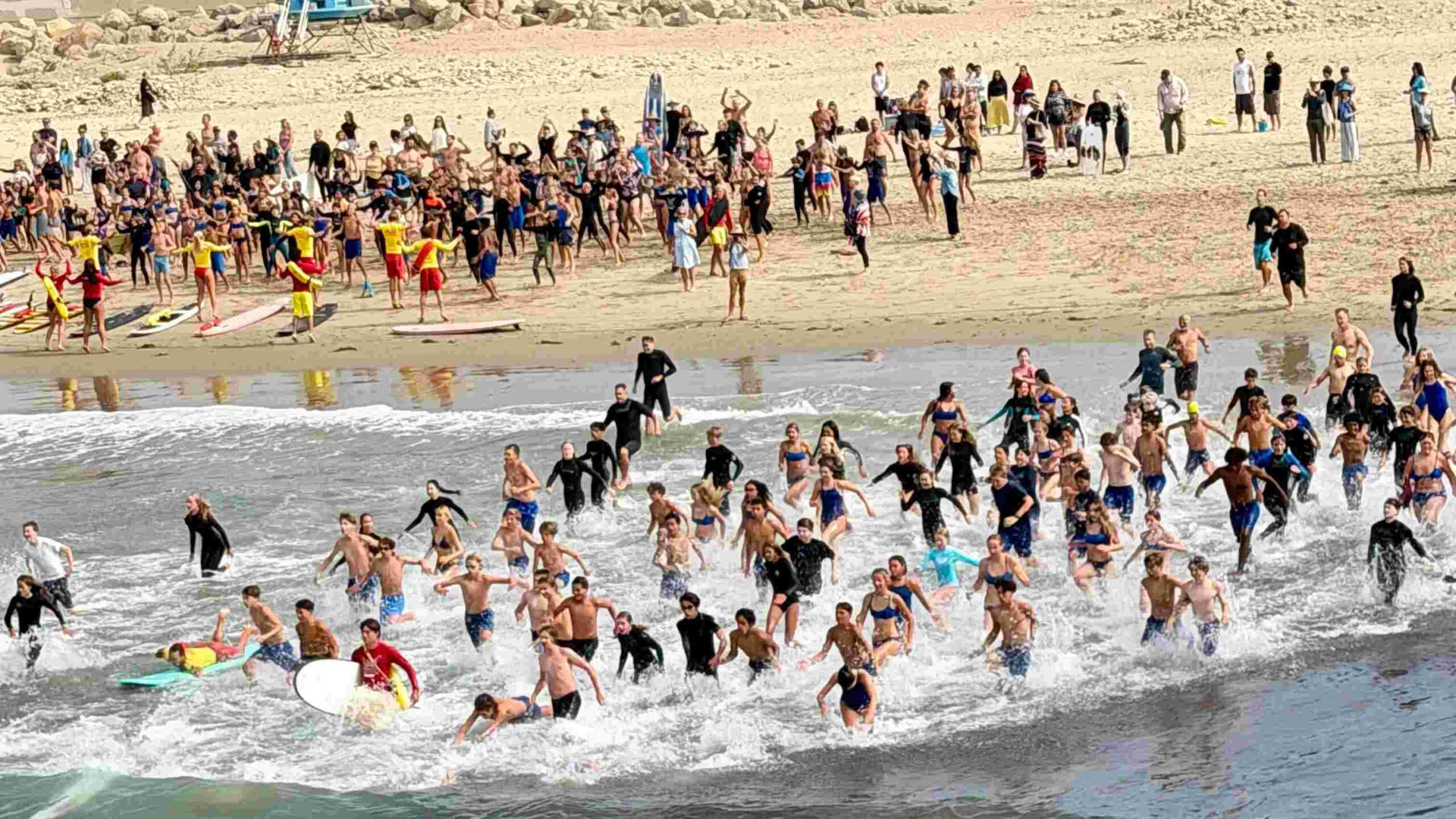 Photo of kids running in to Ocean