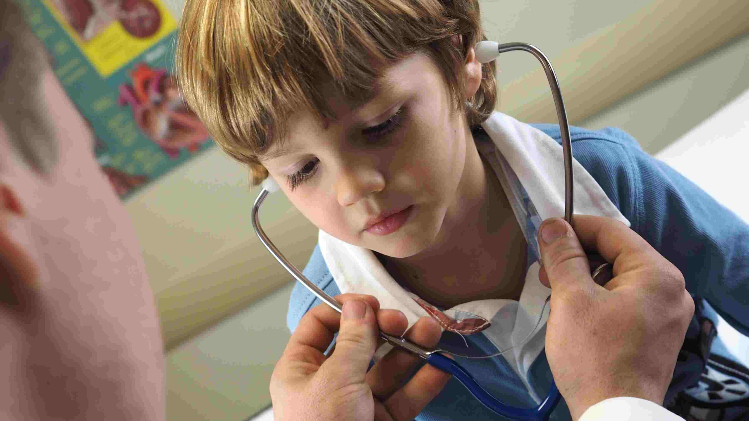 Doctor letting child use stethoscope