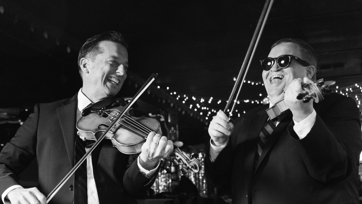 Two musicians playing violin